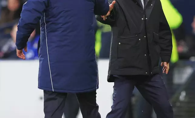 Japan head coach Hajime Moriyasu, right, greets Scotland head coach Steve Clarke at the end of the international friendly soccer match between Scotland and Japan in Glasgow, Scotland, Saturday, March 28, 2026. (AP Photo/Scott Heppell)