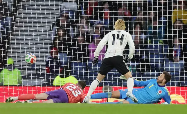 Japan's Junya Ito scores the opening goal during the international friendly soccer match against Scotland, in Glasgow, Scotland, Saturday March 28, 2026. (Steve Welsh/PA via AP)