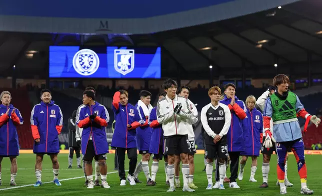 Japan's players celebrate their victory at the international friendly soccer match between Scotland and Japan in Glasgow, Scotland, Saturday, March 28, 2026. (AP Photo/Scott Heppell)