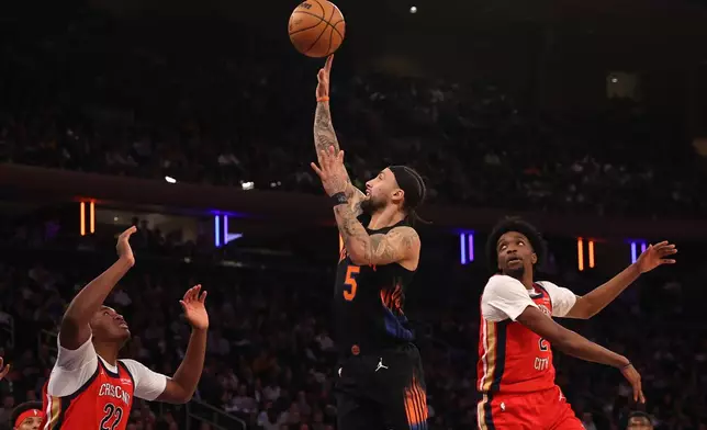 New York Knicks' Jose Alvarado (5) shoots the ball against New Orleans Pelicans' Derik Queen (22) during the first half of an NBA basketball game Tuesday, March 24, 2026, in New York. (AP Photo/Pamela Smith)