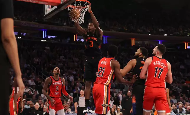 New York Knicks OG Anunoby (8) dunks the ball during the first half of an NBA basketball game against the New Orleans Pelicans, Tuesday, March 24, 2026, in New York. (AP Photo/Pamela Smith)