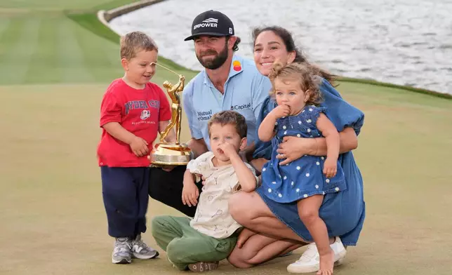 Cameron Young poses with his wife Kelsey, sons John, left, Henry and daughter Vivienne, after he won The Players Championship golf tournament Sunday, March 15, 2026, in Ponte Vedra Beach, Fla. (AP Photo/Gerald Herbert)