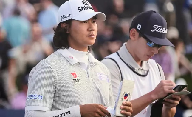 S.H. Kim of South Korea walks to the 17th tee during the first round of The Players Championship golf tournament Thursday, March 12, 2026, in Ponte Bedra Beach, Fla. (AP Photo/Gerald Herbert)
