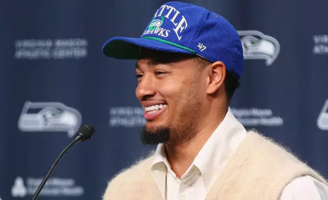 Seattle Seahawks wide receiver Jaxon Smith-Njigba smiles during an NFL football news conference, Wednesday, March 25, 2026, in Seattle. (AP Photo/Kevin Ng)