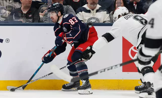 Columbus Blue Jackets' Conor Garland, left, looks for an open pass against Los Angeles Kings' Drew Doughty during the first period of an NHL hockey game, Monday, March 9, 2026, in Columbus, Ohio. (AP Photo/Jay LaPrete)