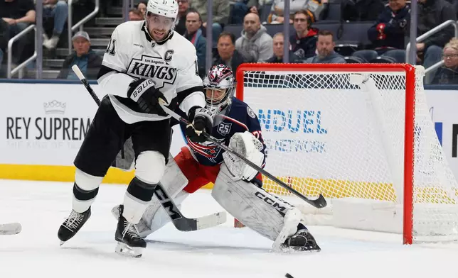 Columbus Blue Jackets' Jet Greaves, right, deflects the puck away from Los Angeles Kings' Anze Kopitar during the second period of an NHL hockey game, Monday, March 9, 2026, in Columbus, Ohio. (AP Photo/Jay LaPrete)