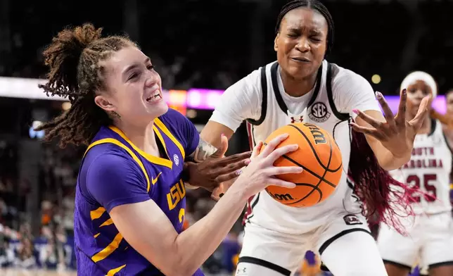 LSU forward Grace Knox vies for the ball with South Carolina forward Maryam Dauda during the first half of an NCAA college basketball game in the semifinals of the Southeastern Conference tournament, Saturday, March 7, 2026, in Greenville, S.C. (AP Photo/Chris Carlson)