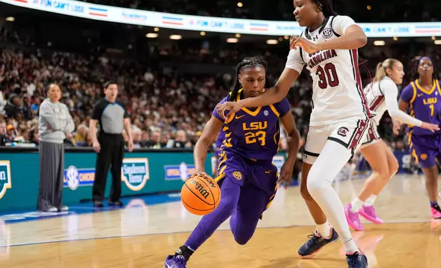 LSU guard Milaysia Fulwiley drives to the basket past South Carolina forward Maryam Dauda during the first half of an NCAA college basketball game in the semifinals of the Southeastern Conference tournament, Saturday, March 7, 2026, in Greenville, S.C. (AP Photo/Chris Carlson)