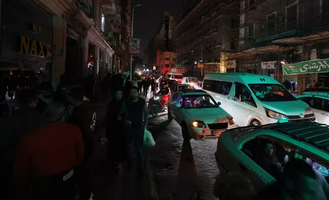 Vehicles drive as light poles are switched off to save electricity, as part of a series of measures the government has taken to mitigate the fallout of the U.S. and Israeli war against Iran, in Cairo, Egypt, Saturday, March 28, 2026. (AP Photo/Khaled Elfiqi)