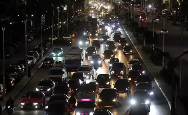 Vehicles drive as light poles are reduced to save electricity, as part of a series of measures the government has taken to mitigate the fallout of the U.S. and Israeli war against Iran, in Cairo, Egypt, Sunday, March 29, 2026. (AP Photo/Khaled Elfiqi)
