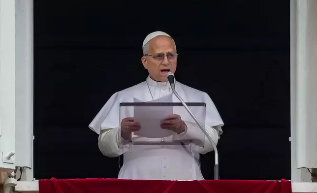 Pope Leo XIV appears at the window of his studio overlooking St. Peter's Square at the Vatican where Catholic faithful and pilgrims gathered for the traditional Sunday blessing at the end of the noon Angelus prayer, Sunday, March 15, 2026. (AP Photo/Andrew Medichini)
