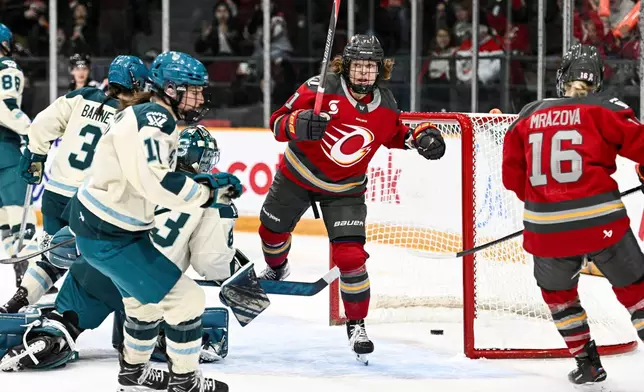 Ottawa Charge's Fanuza Kadirova (centre) spins around as she celebrates her goal on Seattle Torrent goaltender Hannah Murphy (83) during the first period of an PWHL hockey game in Ottawa, Wednesday, March 4, 2026. (Spencer Colby/The Canadian Press via AP)