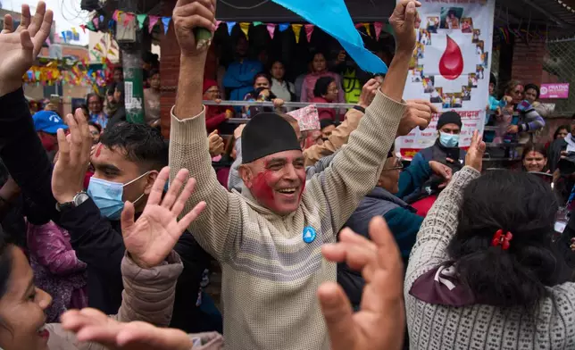 Supporters of Rastriya Swatantra Party celebrate the victory of Ranju Darshana, a candidate for a seat in the House of Representatives in Kathmandu, Nepal, Friday, March 6, 2026. (AP Photo/Niranjan Shrestha)