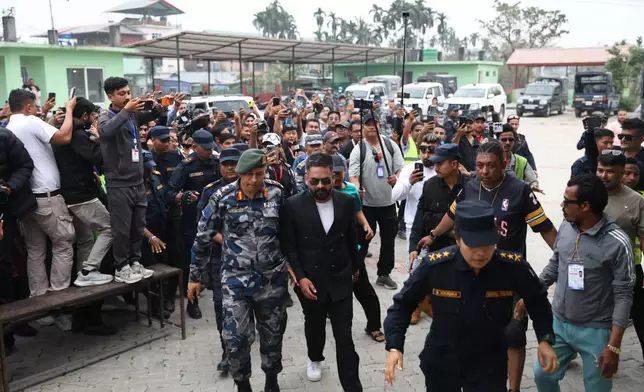 Balendra Shah, foreground, former mayor of Kathmandu Metropolitan City and prime ministerial candidate of the Rastriya Swatantra Party, arrives to receive his victory certificate after defeating former Prime Minister Khadga Prasad Oli of the Communist Party of Nepal–Unified Marxist-Leninist (CPN-UML) in Jhapa, about 267 miles (430 kilometers) southeast of Kathmandu, Nepal, Sunday, March 8, 2026. (AP Photo/Umesh Karki)