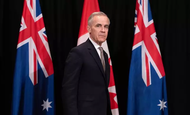 canada's Prime Minister Mark Carney takes his place for a signing ceremony, in Sydney, Australia, on Wednesday, March 4, 2026. (Adrian Wyld/The Canadian Press via AP)