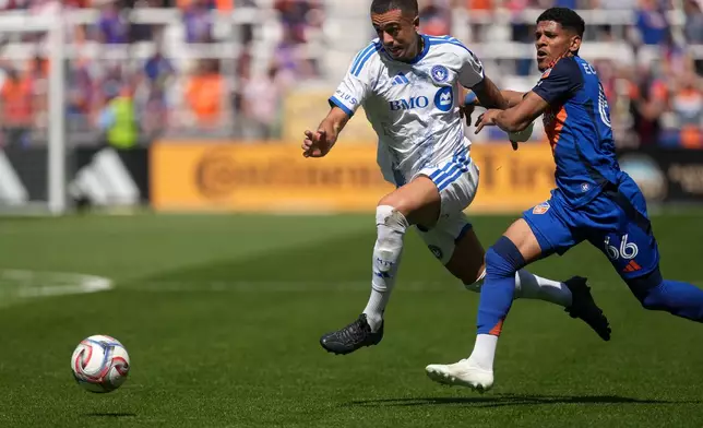 CF Montréal midfielder Iván Jaime, left, dribbles on goal as FC Cincinnati forward Ender Echenique, right, defends during the first half of an MLS soccer match, Sunday, March 22, 2026, in Cincinnati. (AP Photo/Kareem Elgazzar)