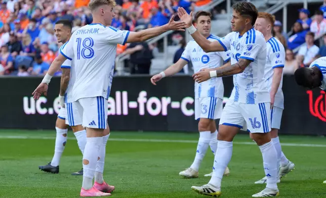 CF Montréal midfielder Wikelman Carmona (16) celebrates after a goal with midfielder Hennadiy Synchuk (18) during the first half of an MLS soccer match against FC Cincinnati, Sunday, March 22, 2026, in Cincinnati. (AP Photo/Kareem Elgazzar)