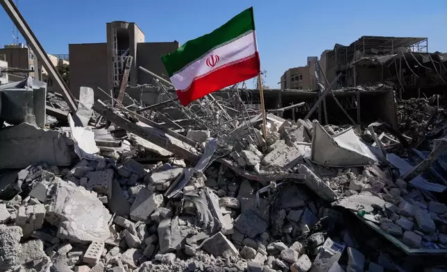 An Iranian flag is placed among the ruins of a police station struck Monday during the U.S.–Israeli military campaign in Tehran, Iran, Tuesday, March 3, 2026. (AP Photo/Vahid Salemi)