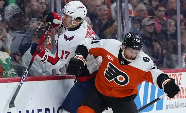 Washington Capitals' Dylan Strome (17) and Philadelphia Flyers' Luke Glendening (41) collide during the second period of an NHL hockey game, Wednesday, March 11, 2026, in Philadelphia. (AP Photo/Matt Rourke)