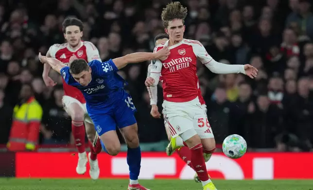 Everton's Vitaliy Mykolenko pulls Arsenal's Max Dowman during the English Premier League soccer match between Arsenal and Everton in London, England, Saturday, March 14, 2026. (AP Photo/Kin Cheung)
