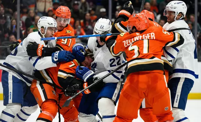 Anaheim Ducks and Toronto Maple Leafs players clash during the second period of an NHL hockey game Monday, March 30, 2026, in Anaheim, Calif. (AP Photo/William Liang)