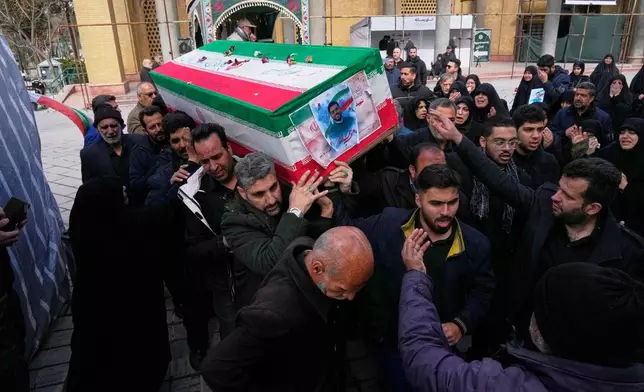 The coffin of Mehdi Hosseini, a man killed in a U.S.-Israeli strike, is carried for burial at Behesht-e Zahra cemetery in Tehran, Iran, Monday, March 9, 2026. (AP Photo/Vahid Salemi)