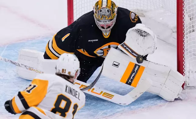 Boston Bruins goaltender Jeremy Swayman (1) makes a save on a shot by Pittsburgh Penguins center Ben Kindel (81) during the second period of an NHL hockey game, Tuesday, March 3, 2026, in Boston. (AP Photo/Charles Krupa)