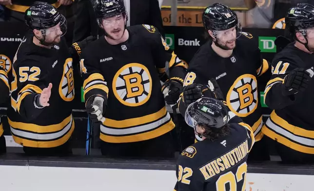 Boston Bruins center Marat Khusnutdinov (92) is congratulated after his goal against the Pittsburgh Penguins during the first period of an NHL hockey game, Tuesday, March 3, 2026, in Boston. (AP Photo/Charles Krupa)