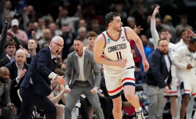 UConn forward Alex Karaban (11) celebrates a three pointer against Michigan State during the second half in the Sweet 16 of the NCAA college basketball tournament, Friday, March 27, 2026, in Washington. (AP Photo/Stephanie Scarbrough)