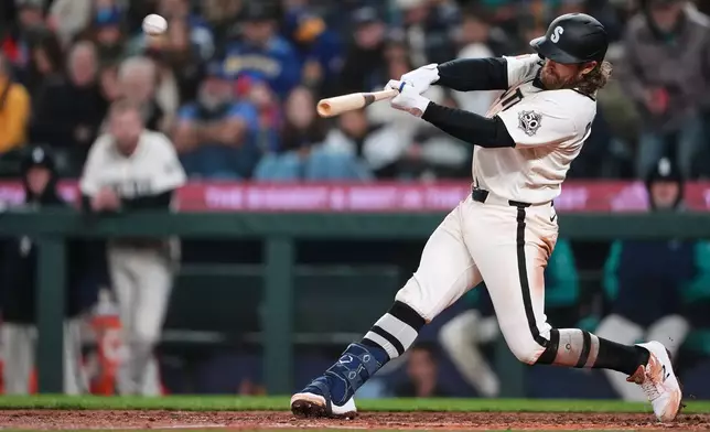 Seattle Mariners' Brendan Donovan hits a three-run home run against the Cleveland Guardians during the fourth inning of a baseball game, Sunday, March 29, 2026, in Seattle. (AP Photo/Lindsey Wasson)