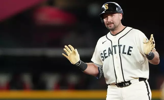 Seattle Mariners' Cal Raleigh reacts after hitting an RBI ground rule double against the Cleveland Guardians during the sixth inning of a baseball game, Sunday, March 29, 2026, in Seattle. (AP Photo/Lindsey Wasson)