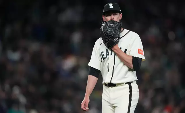 Seattle Mariners starting pitcher Emerson Hancock walks to the dugout after holding the Cleveland Guardians hitless through six innings of a baseball game, Sunday, March 29, 2026, in Seattle. (AP Photo/Lindsey Wasson)