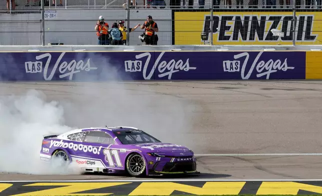 Denny Hamlin (11) performs a burnout after winning a NASCAR Cup Series auto race at Las Vegas Motor Speedway, Sunday, March 15, 2026, in Las Vegas. (AP Photo/Steve Marcus)