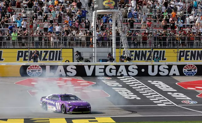 Denny Hamlin (11) performs a burnout after winning a NASCAR Cup Series auto race at Las Vegas Motor Speedway, Sunday, March 15, 2026, in Las Vegas. (AP Photo/Steve Marcus)