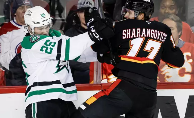 Dallas Stars' Arttu Hyry, left, checks Calgary Flames' Yegor Sharangovich during the second period of an NHL hockey game in Calgary, Alberta on Tuesday, March 3, 2026. (Jeff McIntosh/The Canadian Press via AP)