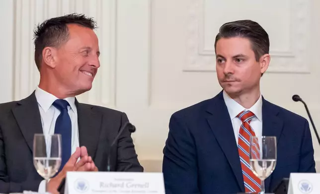 Kennedy Center President Richard Grenell, left, and Matt Floca are seated as President Donald Trump speaks during a board meeting of the John F. Kennedy Memorial Center For The Performing Arts in the East Room of the White House, Monday, March 16, 2026, in Washington. (AP Photo/Alex Brandon)