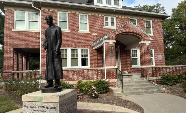 A statue of the Rev. Edward Flanagan is seen outside the home where he lived in Boys Town, Neb., on Sept. 14, 2024. (AP Photo/Peter Smith)