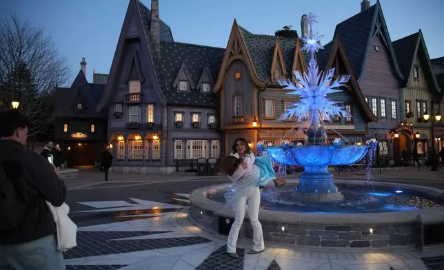 Visitors enjoy the new theme World of Frozen during its inauguration at Disneyland Paris in Marne-la-Vallee, east of Paris, Saturday, March 28, 2026. (AP Photo/Christophe Ena)