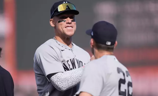 New York Yankees' Aaron Judge, left, celebrates with Ben Rice after a baseball game against the San Francisco Giants in San Francisco, Friday, March 27, 2026. (AP Photo/Jeff Chiu)
