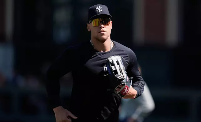 New York Yankees' Aaron Judge jogs on the field while warming up before a baseball game against the San Francisco Giants in San Francisco, Saturday, March 28, 2026. (AP Photo/Jeff Chiu)