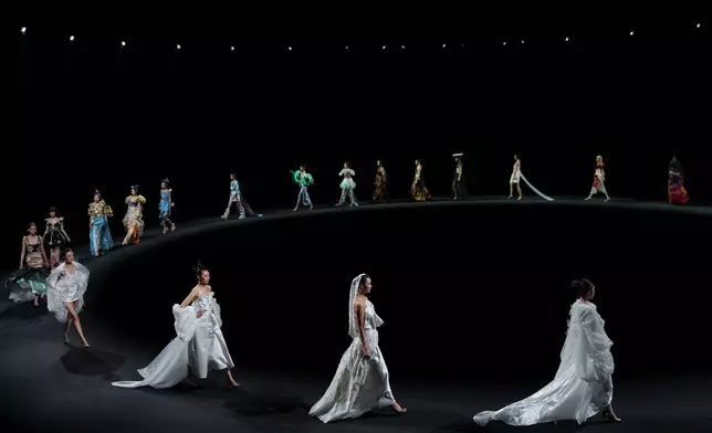 Models wear creations by "The Urban Plette" Weaving Starry Dreams China International Children Designer Competition during China Fashion Week (Spring) 2026 in Beijing, China, Sunday, March 22, 2026. (AP Photo/Vincent Thian)