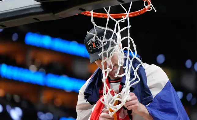 Illinois' Zvonimir Ivisic cuts part of the net after an Elite Eight game against Iowa in the NCAA college basketball tournament Saturday, March 28, 2026, in Houston. (AP Photo/Ashley Landis)