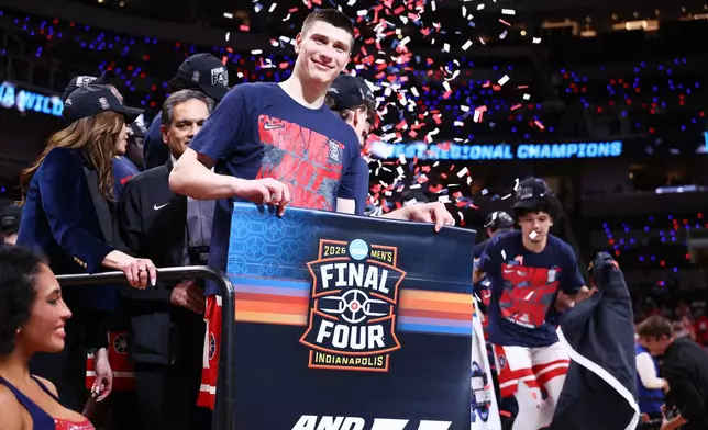 Arizona forward Ivan Kharchenkov smiles on the stage after a win over Purdue in the Elite Eight of the NCAA college basketball tournament, Saturday, March 28, 2026, in San Jose, Calif. (AP Photo/Kelley L Cox)