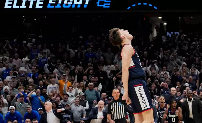 UConn guard Braylon Mullins (24) celebrates after a basket against Duke during the second half in the Elite Eight of the NCAA college basketball tournament, Sunday, March 29, 2026, in Washington. (AP Photo/Stephanie Scarbrough)