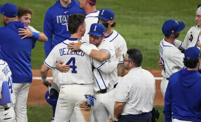 The Italy team console each other after losing to Venezuela at a World Baseball Classic semifinal game, Monday, March 16, 2026, in Miami. (AP Photo/Lynne Sladky)