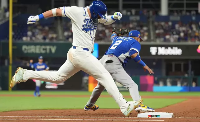 Venezuela first baseman Luis Arraez (2) catches the ball as Italy Vinnie Pasquantino is out on first base during the second inning of a World Baseball Classic semifinal game, Monday, March 16, 2026, in Miami. (AP Photo/Rebecca Blackwell)