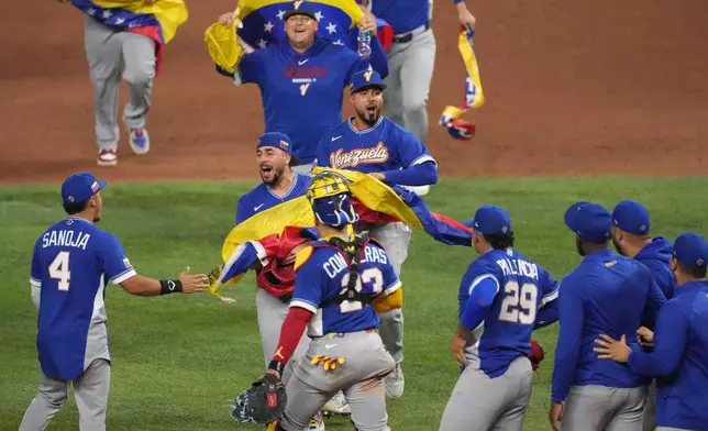 The Venezuela team celebrates after defeating Italy at a World Baseball Classic semifinal game, Monday, March 16, 2026, in Miami. (AP Photo/Lynne Sladky)