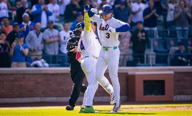New York Mets' Carson Benge (3) celebrates scoring a home run during the sixth inning of his debut MLB game, an opening-day baseball game against the Pittsburgh Pirates, Thursday, March 26, 2026, in New York. (AP Photo/Angelina Katsanis)