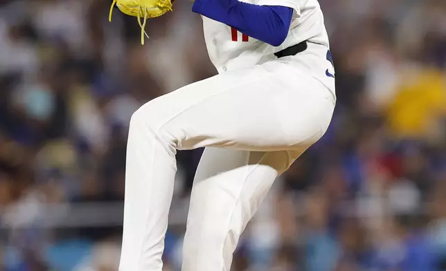 Los Angeles Dodgers starting pitcher Roki Sasaki (11) pitches during the second inning of a baseball game against the Cleveland Guardians, Monday, March 30, 2026, in Los Angeles. (AP Photo/Caroline Brehman)