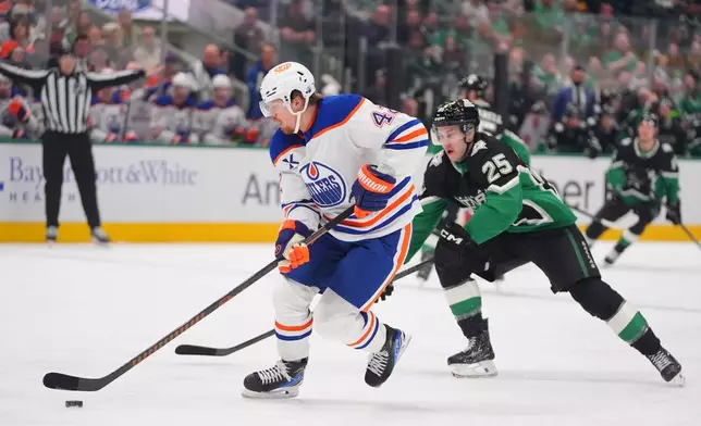 Edmonton Oilers right wing Kasperi Kapanen (42) skates with the puck against Dallas Stars right wing Arttu Hyry (25) during the first period of an NHL hockey game Thursday, March 12, 2026, in Dallas. (AP Photo/LM Otero)